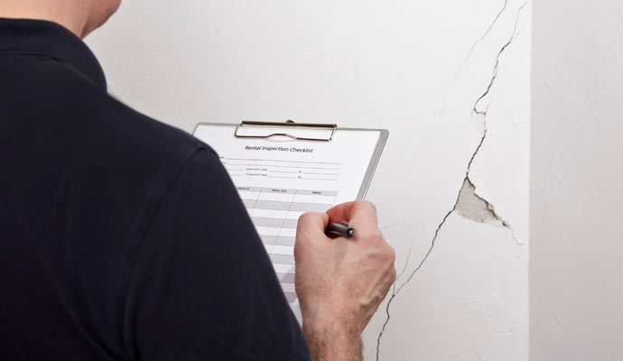 worker inspecting foundation leak